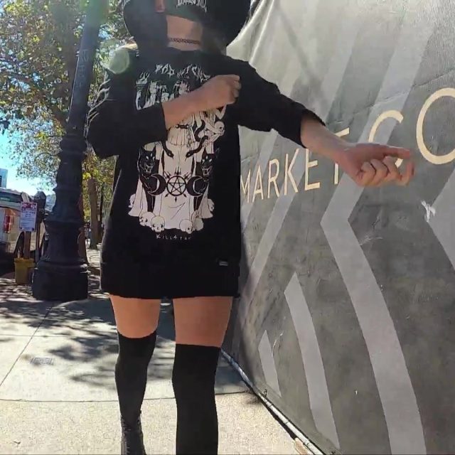 Goth Woman Gives Brief Flashes Beneath Her Sweater on a City Walk — Preview
